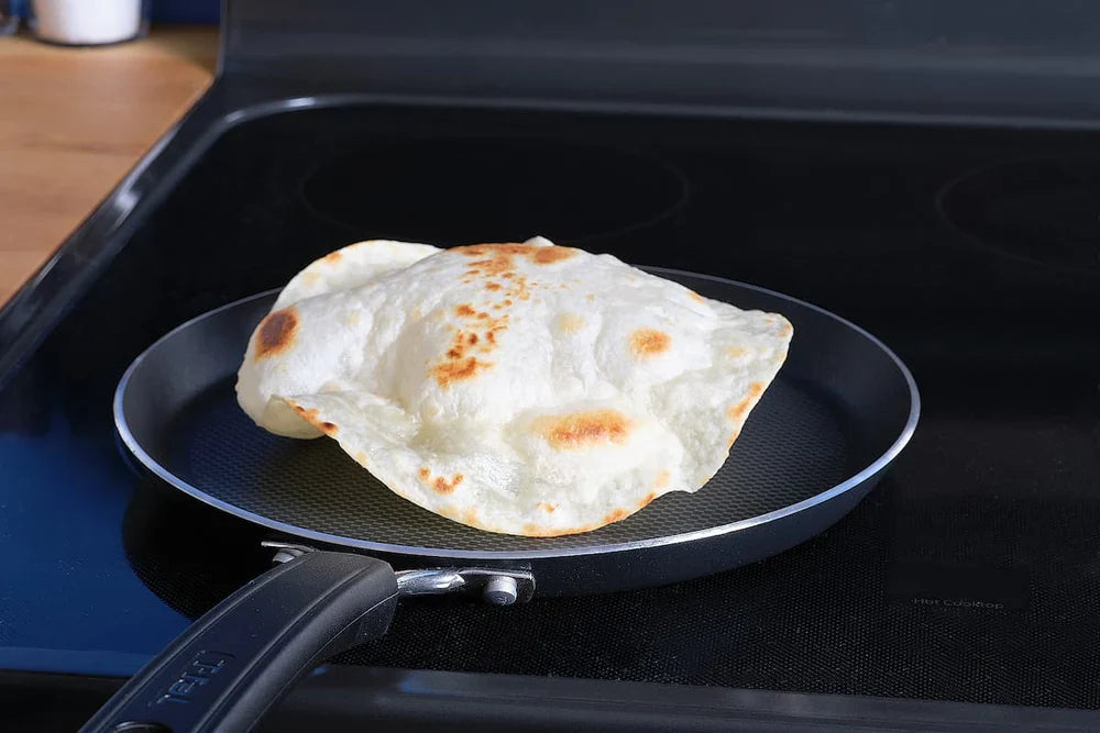 A puffed-up Sonoran-style Rise & Puff tortilla on a pan.