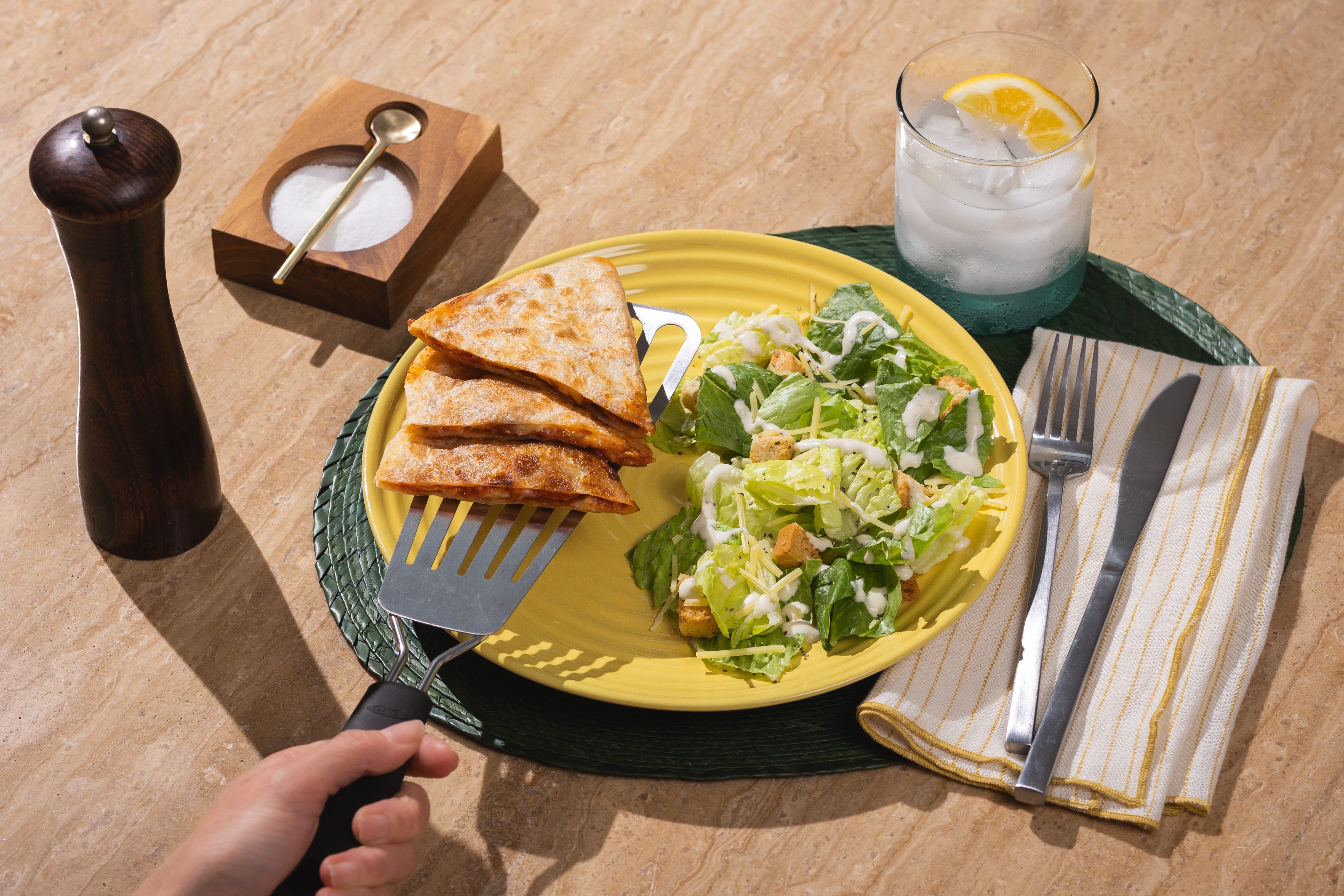 Crispy Rise & Puff quesadilla slices served with Caesar salad on a yellow plate for a fresh, balanced meal.