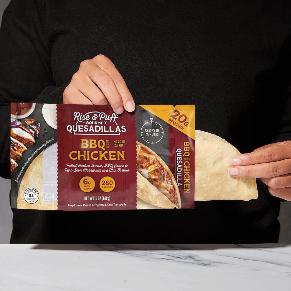 Person holding a Rise & Puff BBQ Chicken quesadilla package