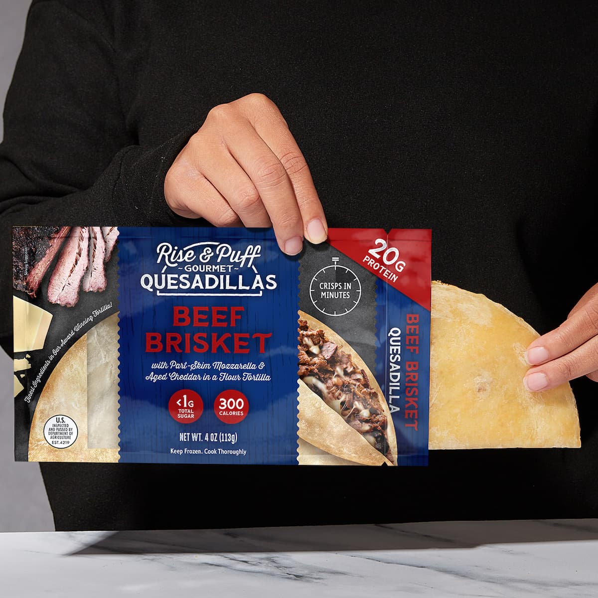 Juicey beef brisket quesadilla being pulled out of packaging