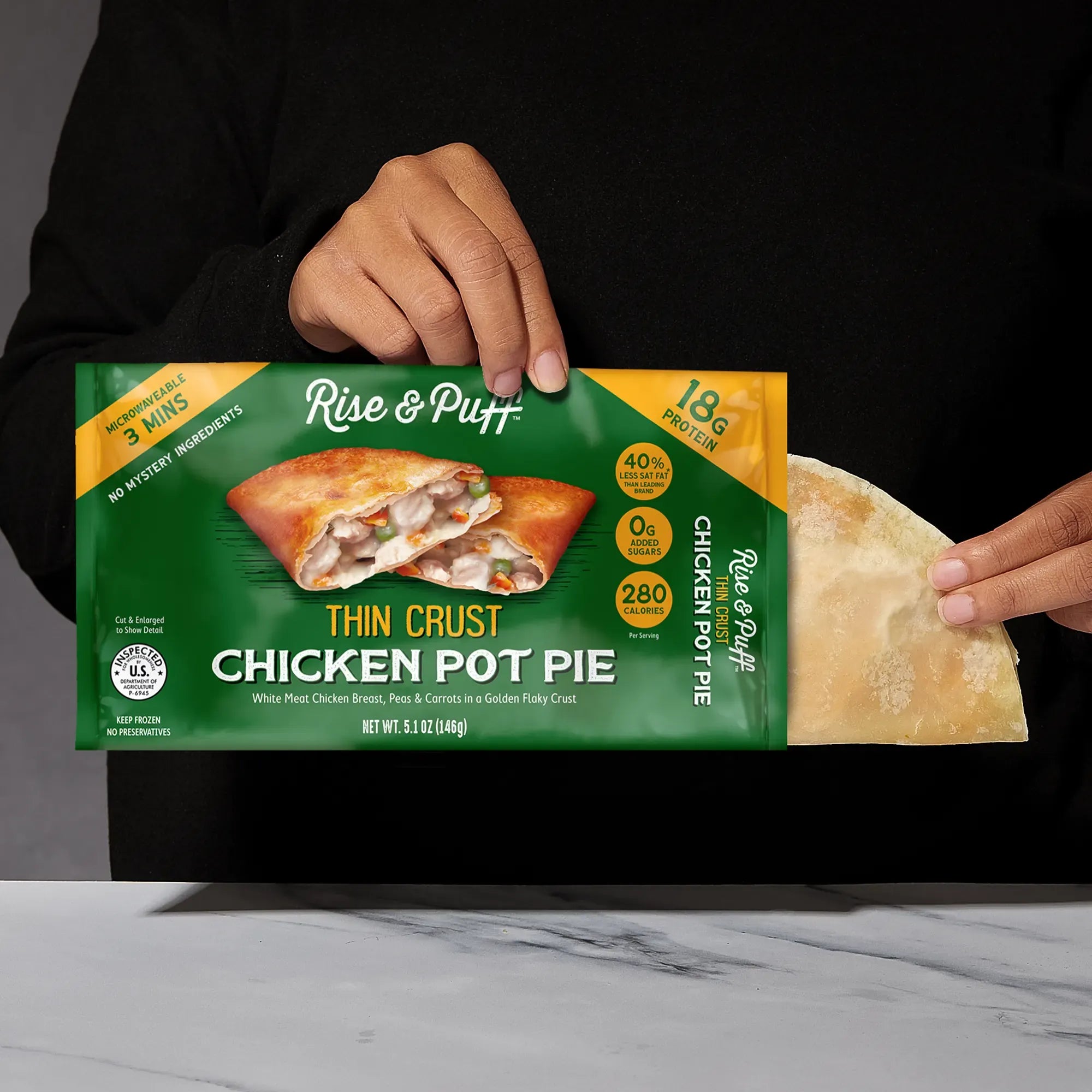 Rise & Puff Thin Crust Chicken Pot Pie shown coming out of its frozen retail packaging