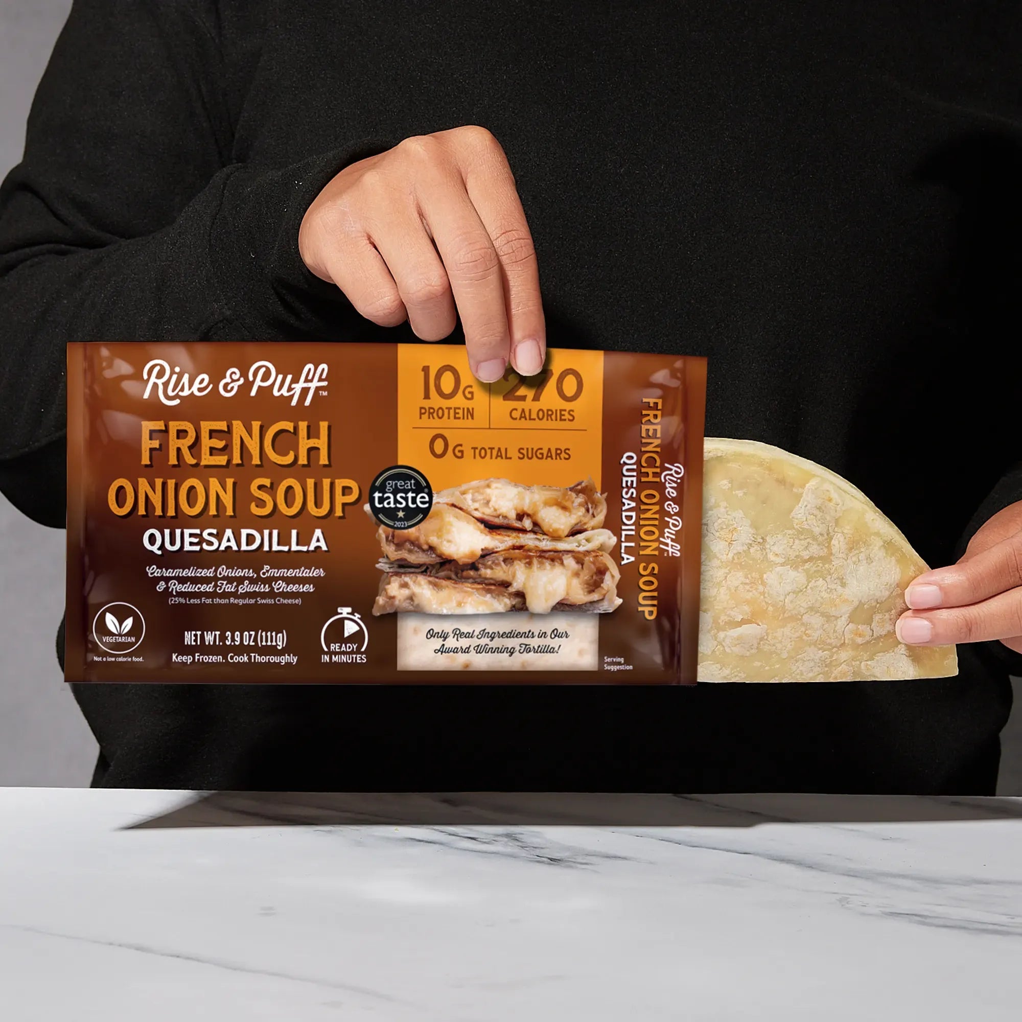 Rise & Puff French Onion Soup Quesadilla shown coming out of its frozen retail packaging