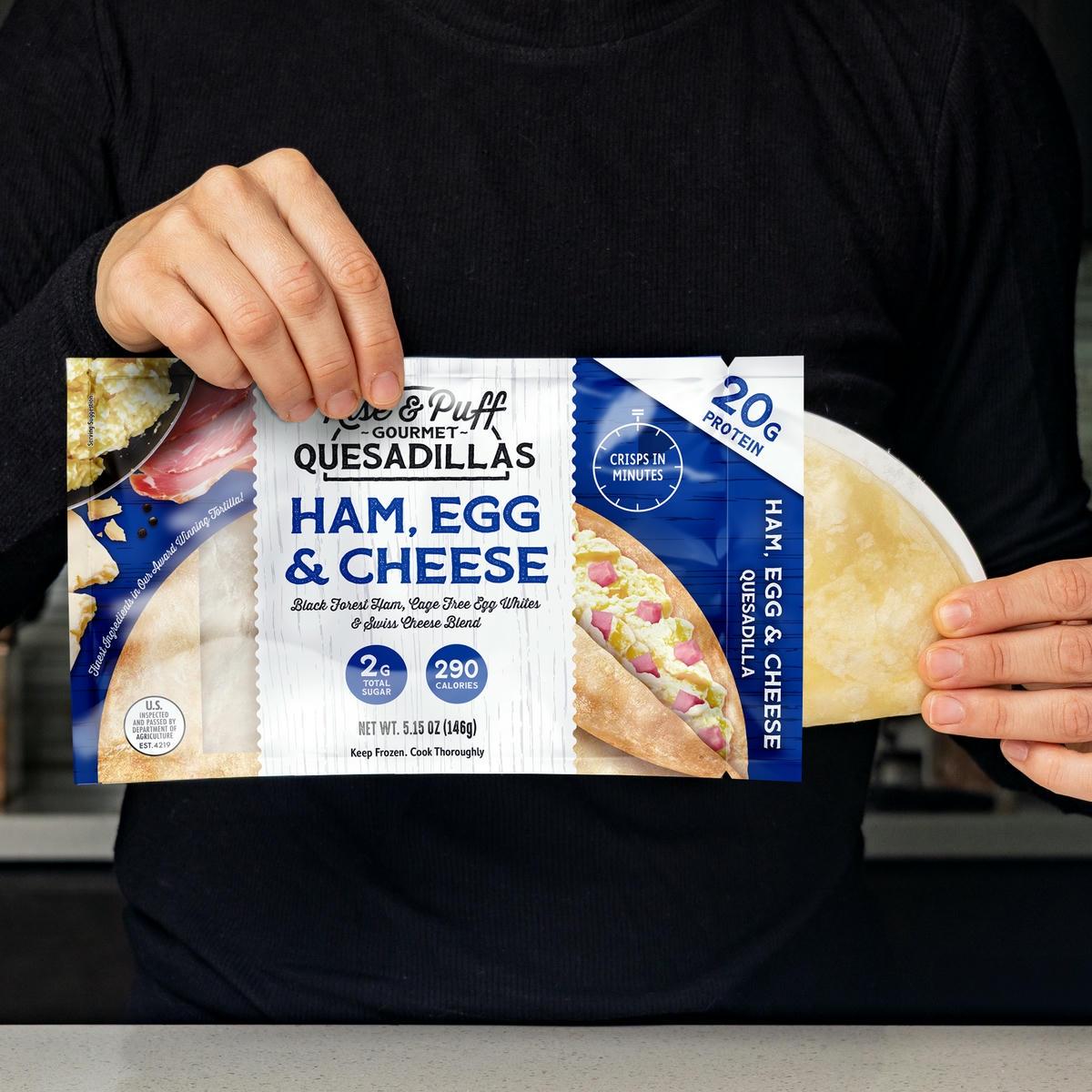 Rise & Puff Ham Egg & Cheese Breakfast Quesadilla being pulled out of packaging