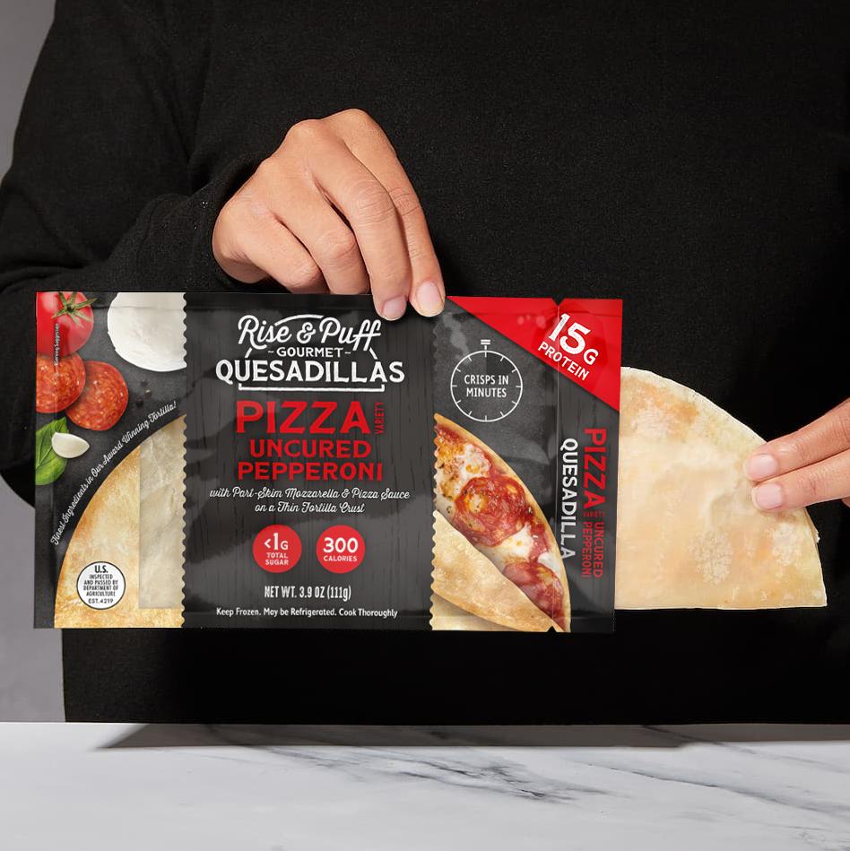 Rise & Puff Pepperoni Pizza Quesadilla being pulled out of packaging