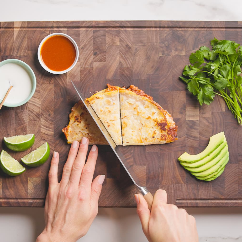 Quesadilla with fresh ingredients on cutting board