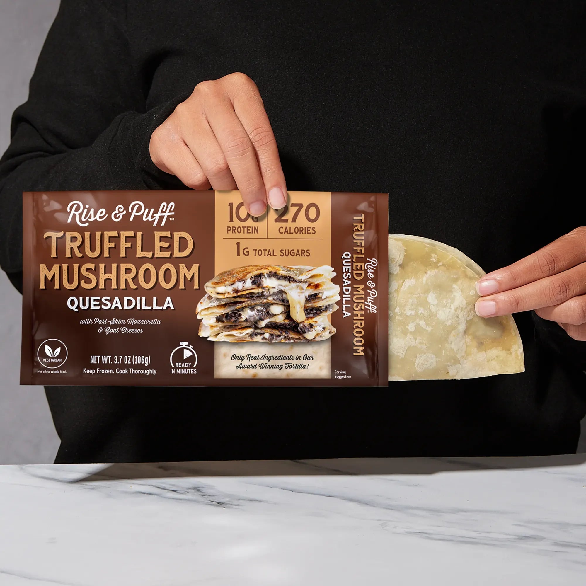 Rise & Puff Truffled Mushroom Quesadilla shown coming out of its frozen retail packaging