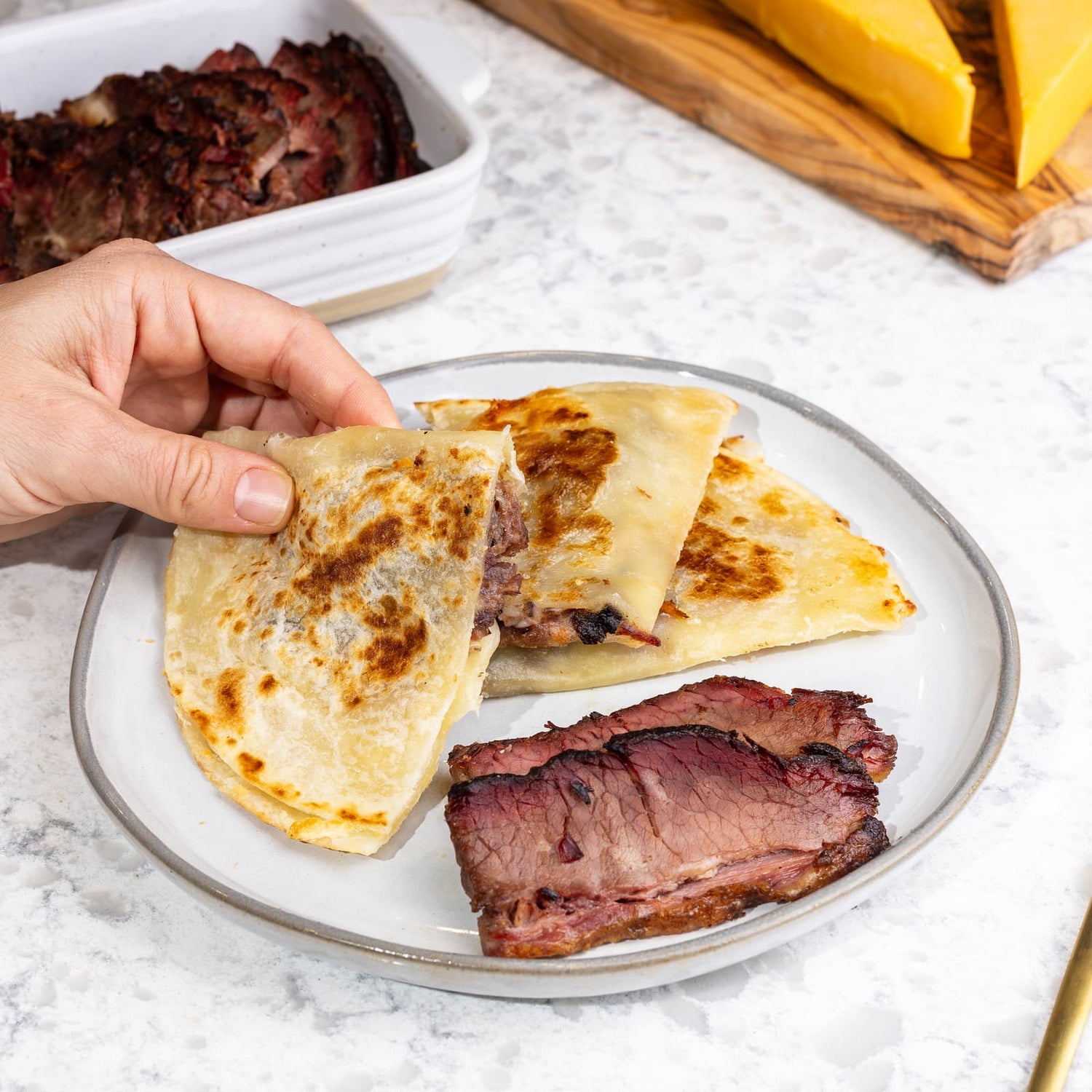 A picture of Rise & Puff’s Smokey Beef Brisket Quesadilla served on a plate.