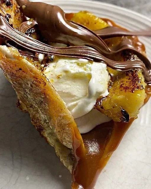 Rise & Puff tortilla dessert filled with melted chocolate and topped with sweet garnishes. The warm tortilla is folded around a gooey chocolate filling for an easy homemade treat.