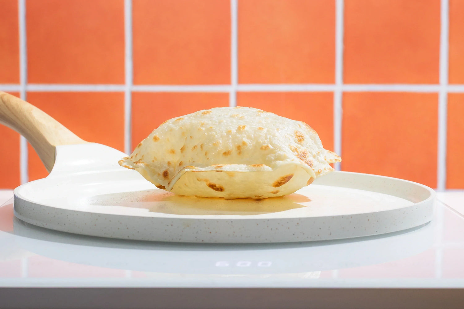Rise & Puff tortilla puffing up in a hot pan as it cooks, showing the light, soft texture achieved after heating.