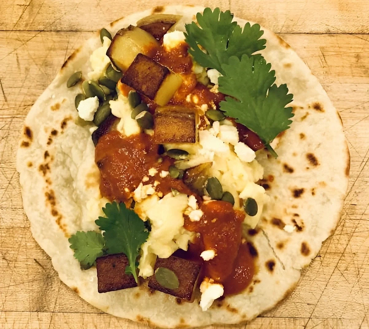 Rise & Puff tortilla topped with colorful chopped vegetables and melted cheese.