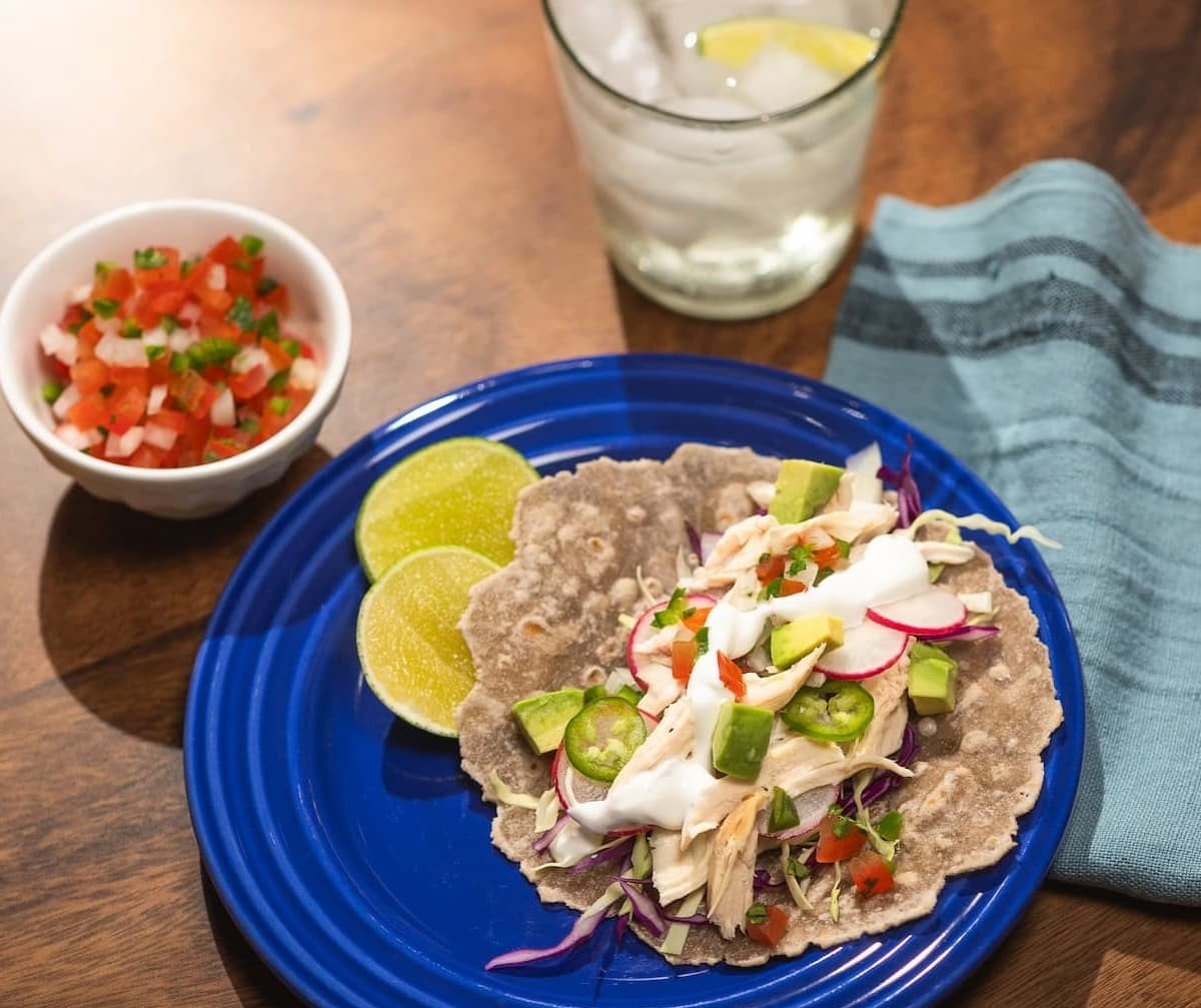 A picture of Rise & Puff’s Gluten-Free Tortilla on a plate with a drink and salsa.