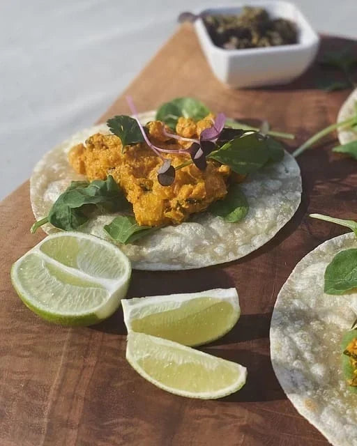  A homemade tortilla made with Rise & Puff placed on a wooden board with other savories.