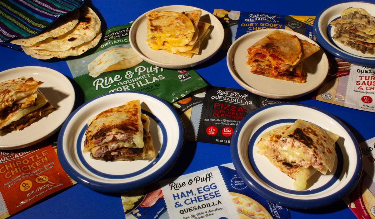 An image of many of the Rise & Puff products featuring healthier quesadillas and pies on white plates along with the packaging of the tortillas and quesadillas