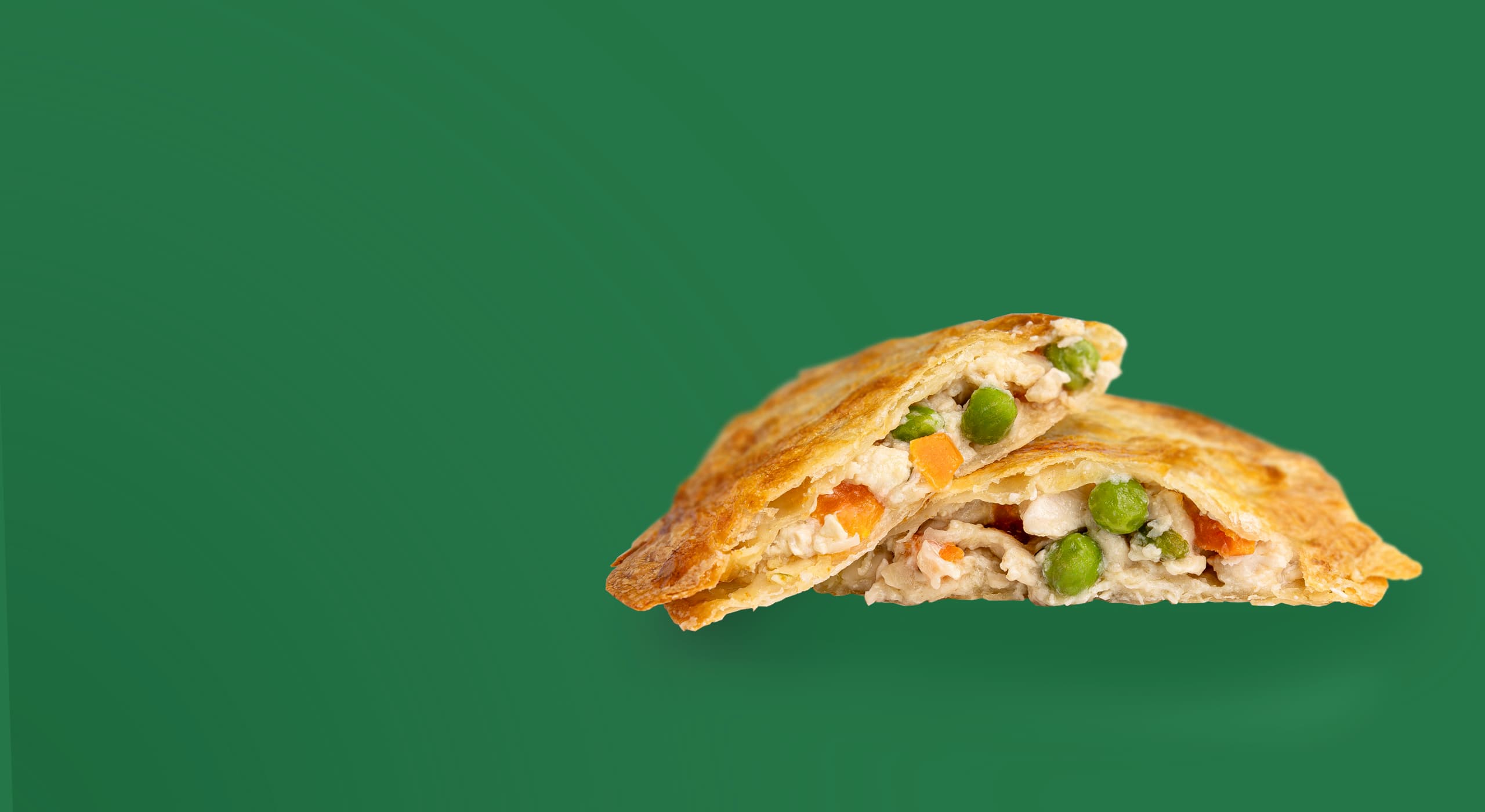 Rise & Puff thin crust Chicken Pot Pie with white-meat chicken, peas, and carrots with a green background