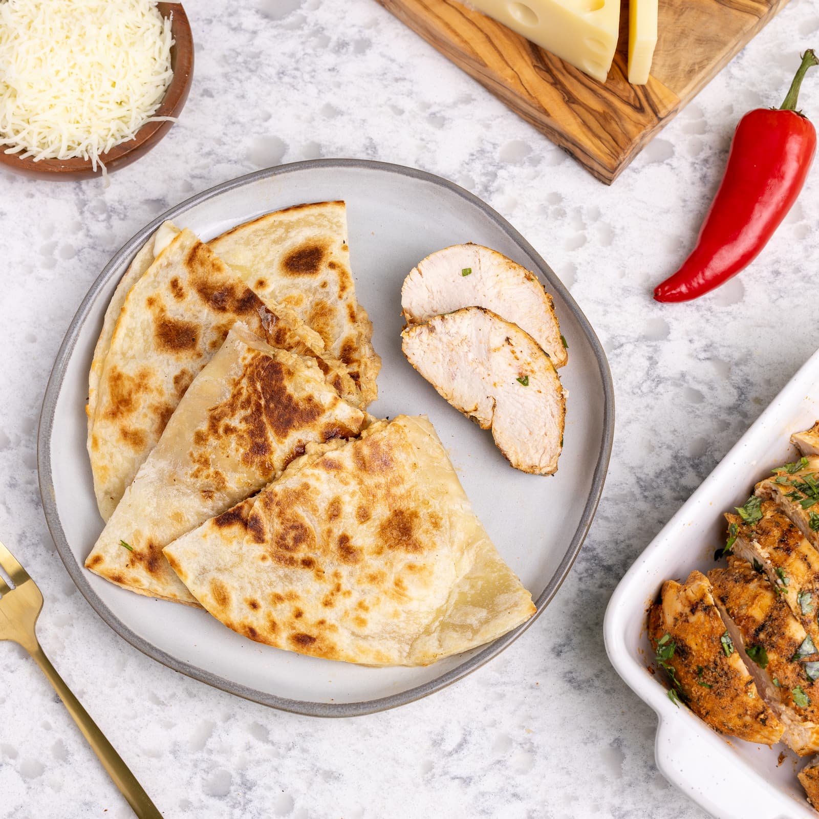 Healthy chipotle chicken quesadilla on plate with ingredients