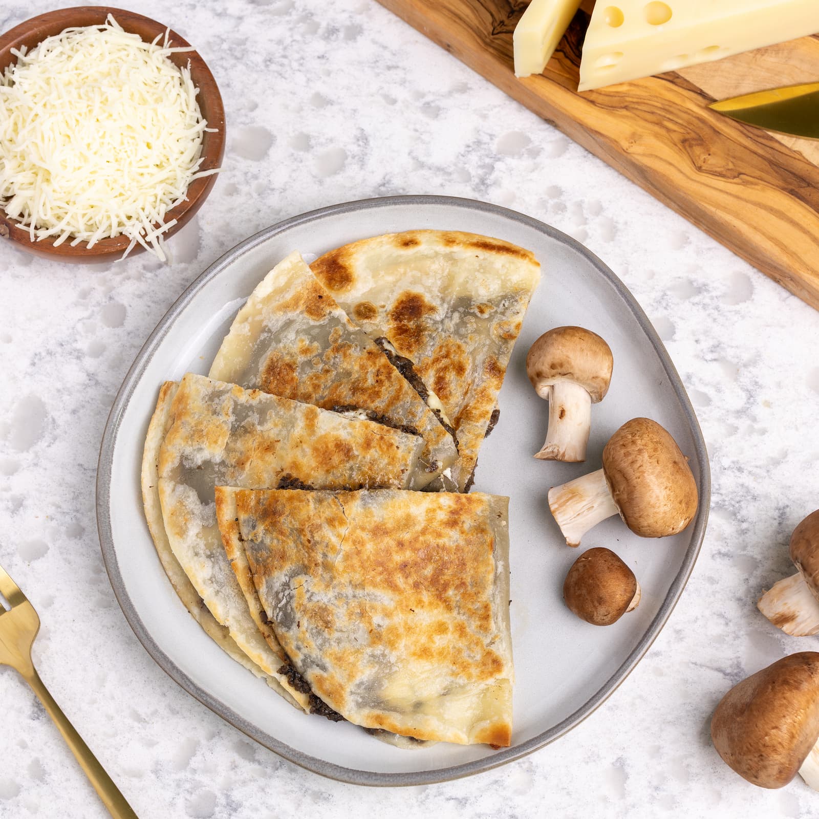 Healthy truffle and mushroom quesadilla with ingredients on plate